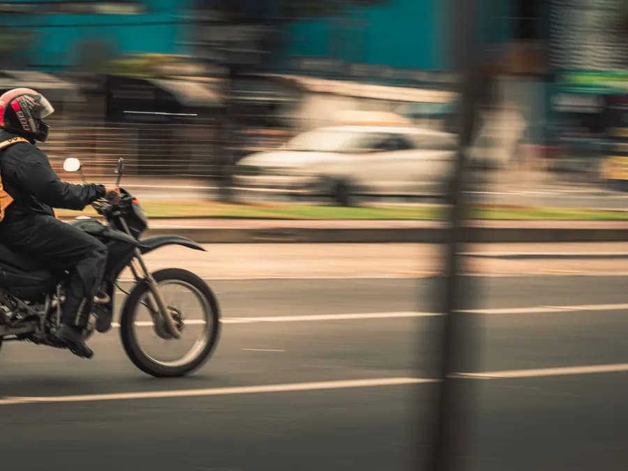 Motorcycle courier riding through a city